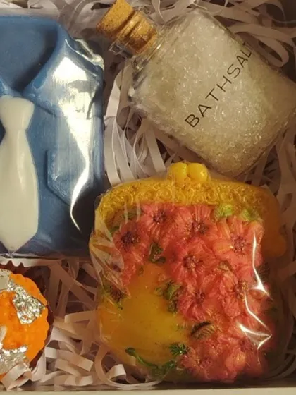 A Rakshabandhan hamper for a brother and sister-in-law, featuring a shirt soap for him and a floral purse soap for her.