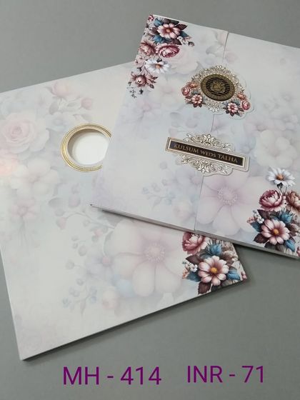 This invitation features a beautiful watercolor floral print and a unique die-cut opening. The design is modern, artistic, and comes with matching inserts.