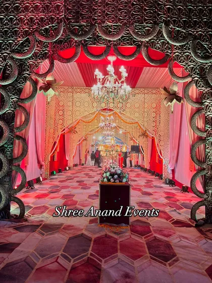 A head-on view through a grand archway, showing the layers of chandeliers and decor that create a deep, immersive experience for arriving guests.