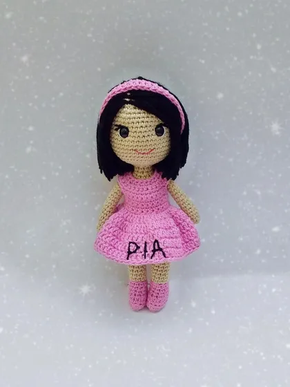 This is a custom doll I made, personalized with the name 'Pia' embroidered on her little pink dress. Adding a name is a sweet way to make a handmade gift even more special.