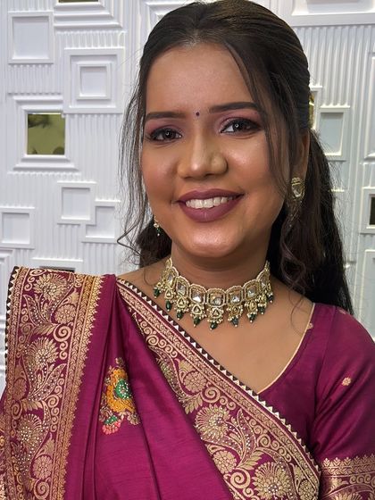A close up of this engagement bride's beautiful smile. Her makeup features a bold mauve lip and shimmery pink eyeshadow, which looks stunning with her traditional saree.