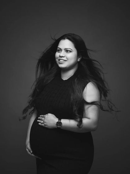 A stunning black and white portrait with a touch of glamour. The wind-swept hair adds movement and drama to this beautiful shot of the mother-to-be.