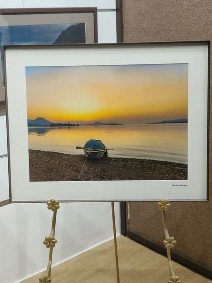 Another breathtaking photograph by Bhaskar Sitholey, this time a serene sunset over a lake, given a classic presentation with a metal frame and white mat.