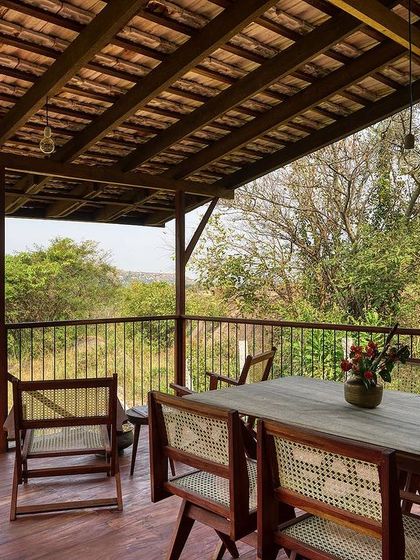 The spacious wooden deck serves as an outdoor dining and living room, extending the usable area of the small cottage.