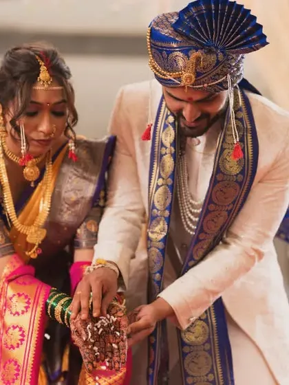 The couple participating in a traditional Maharashtrian wedding ritual. We ensure every important custom is photographed with clarity and respect.