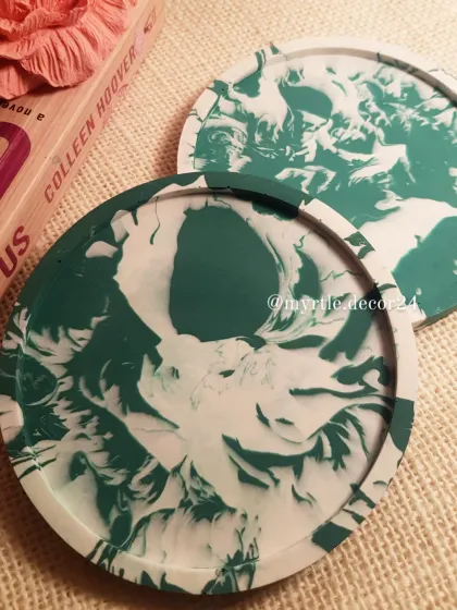 A set of our round coasters in a striking green and white marble pattern. Each coaster is sealed to be water-resistant and backed with cork to protect your furniture.