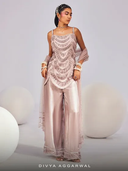 This lilac Ella Kurti Set is your go-to for wedding nights, featuring a delicately embellished top, satin pants, and a matching dupatta.