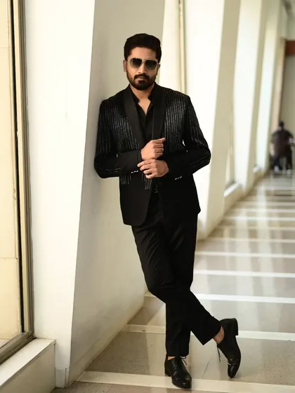 A full-length shot of a client in our black sequin blazer, showcasing its tailored fit and contemporary style.
