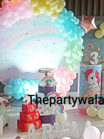 A cute unicorn theme with "My Little Pony" characters. The pastel rainbow backdrop and themed pedestals are perfect for a 3rd birthday party.