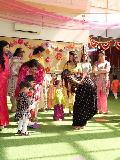 I love interacting with each child during our events. Here, I am sharing a happy moment with the kids and their mothers at our Diwali Dandiya party.