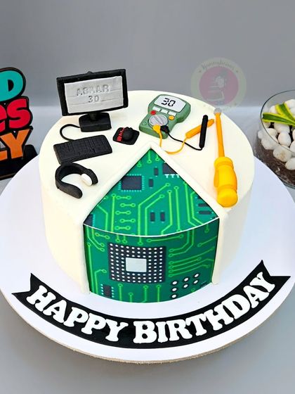 A clever cake for a computer engineer, with a cut-out revealing an edible circuit board inside.