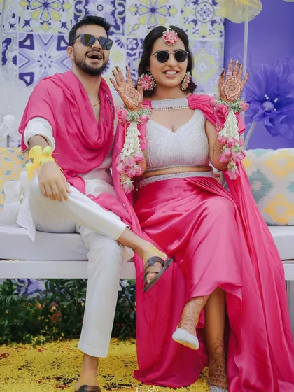 Our bride Pragya looking absolutely stunning in a modern pink outfit for her Haldi. We love when brides experiment with contemporary looks, and we design the decor to complement their style.
