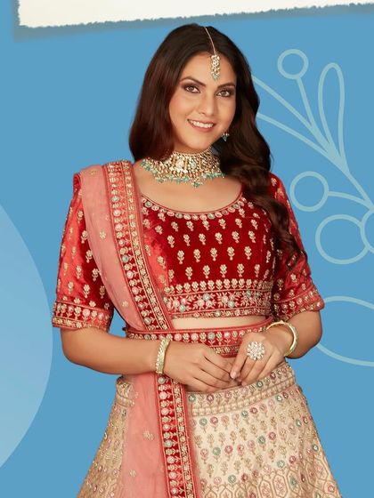 This classic lehenga with delicate embroidery is a true eye-catcher. The combination of a red velvet blouse and a cream skirt offers a timeless and elegant bridal look.