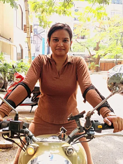 A graduate looking confident and stylish on her bike. Our training helps you find your power and express your personality as a rider.