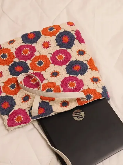 This image shows how a laptop fits snugly inside the tote. I made sure the dimensions are generous, so it can function as your go-to work or student bag without sacrificing its bohemian style.