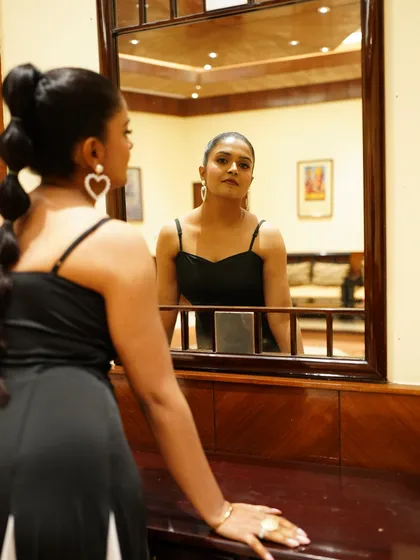 A mirror shot showing the back of the dress and the elegant silhouette. This black and white gown is a timeless piece, perfect for any formal corporate event or awards dinner.