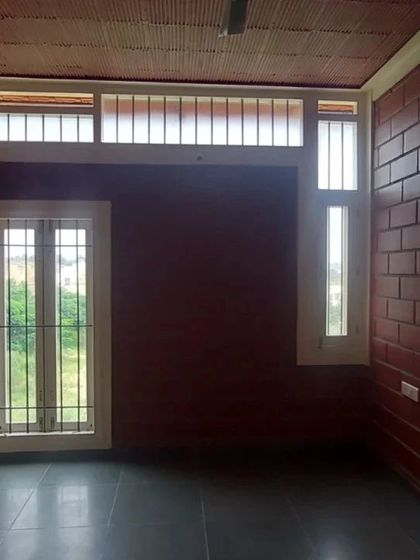 An interior room with exposed brick walls and high windows (clerestory windows) that let in light while maintaining privacy.