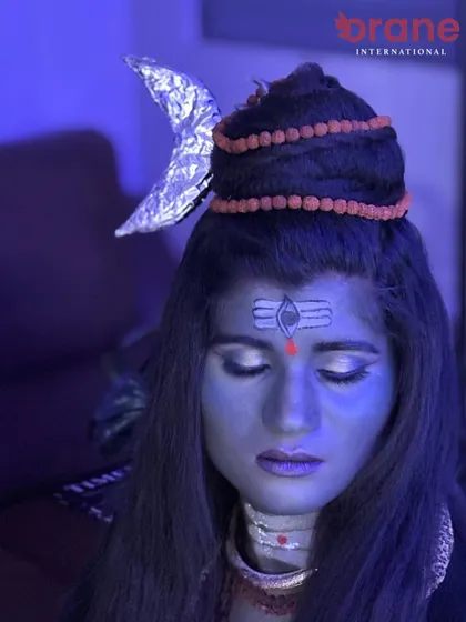 Creative lighting enhances the mystical and divine mood of the Shiva-inspired makeup.