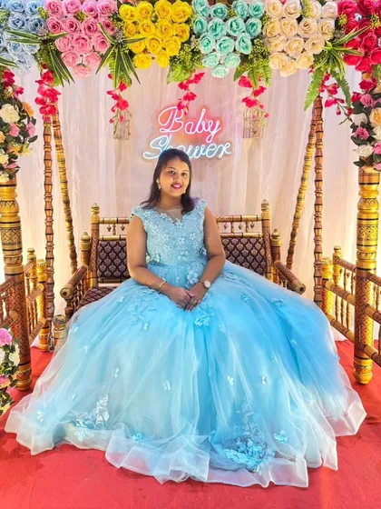 Feel like a princess at your baby shower in this dreamy sky blue ball gown. The full tulle skirt and delicate floral details make it the perfect choice for celebrating your little one's upcoming arrival in style.