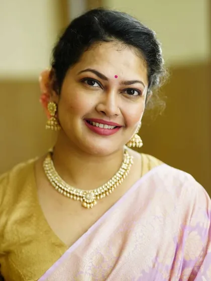 A beautiful portrait of Priyanka Barve before her performance, highlighting the pearl jewellery and soft glam makeup.