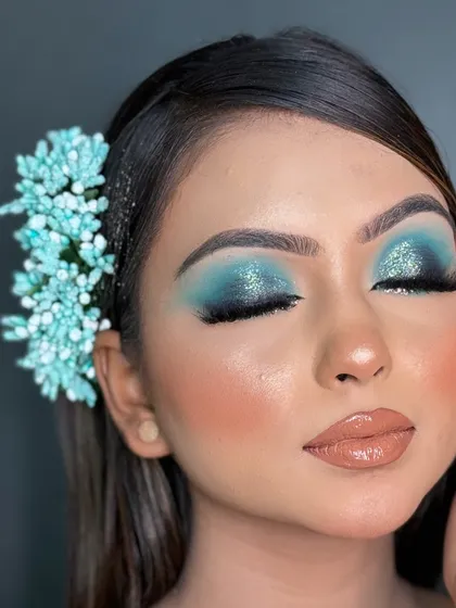 Another angle of the blue smokey eye, showing how the glitter catches the light. Learning to create such detailed and clean eye looks will set you apart as a makeup artist.