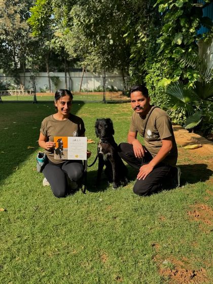 Shifu with his certificate, posing with me and one of our dedicated handlers. A true team success.