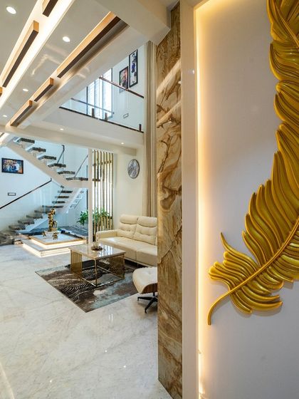 A large, back-lit golden feather art piece serves as a unique focal point in the living area, showcasing our love for artistic details.