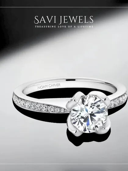 A floral-inspired solitaire that feels delicate yet significant. This ring features a brilliant round diamond held in a unique petal-like setting, a beautiful symbol of a love in bloom.