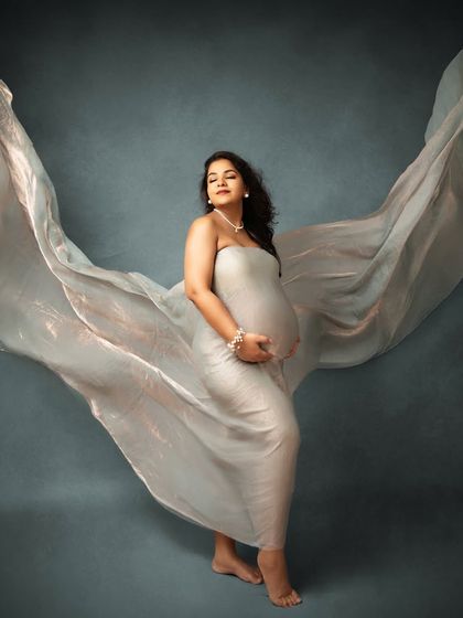Creating angelic wings with flowing fabric. This is one of my signature studio shots, designed to make you feel powerful and beautiful, like a goddess of motherhood.