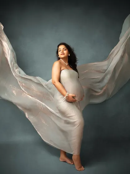 Creating angelic wings with flowing fabric. This is one of my signature studio shots, designed to make you feel powerful and beautiful, like a goddess of motherhood.