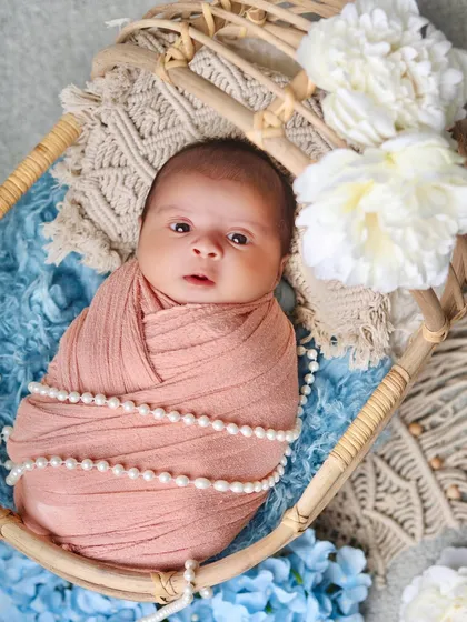 A direct and engaging portrait of an awake baby looking right at the camera. These expressive shots are a treasure for parents.