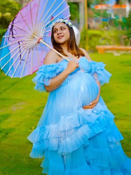 This light blue ruffled gown, paired with a colorful parasol, creates a playful and charming look. It shows how you can accessorize my rental gowns to match your personal style.