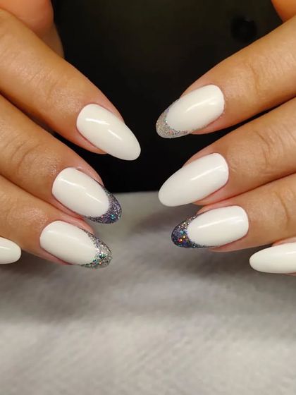 A chic and modern design combining solid matte white nails with a reverse French tip in holographic glitter. This high-contrast look is both elegant and edgy.