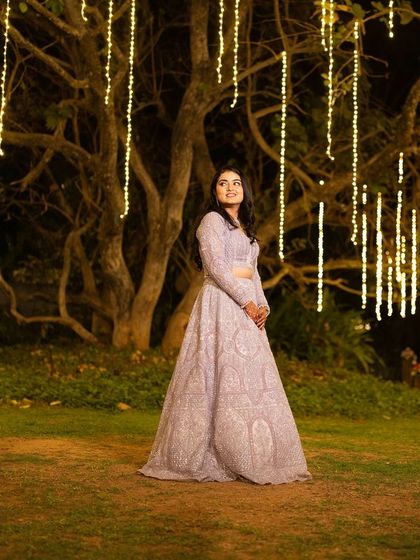 A magical shot of the bride at her Sangeet. The fairy lights create a beautiful bokeh effect, and her makeup is designed to glow in the warm evening light.