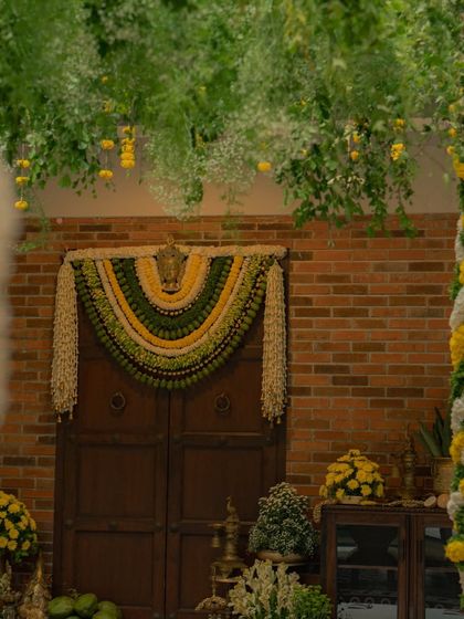 A wider view of the entrance, where the lush green canopy and the detailed floral toran come together. My goal is always to create a cohesive visual story that starts from the moment your guests walk in.
