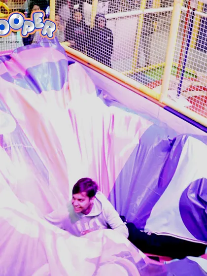 A guest playfully tumbles into one of our giant, soft, inflatable structures.