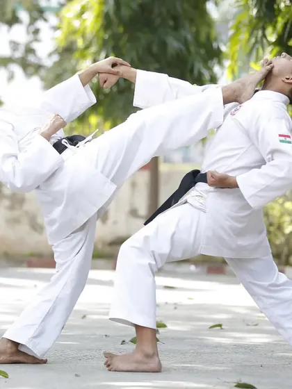 Here I am demonstrating a controlled Jodan Mawashi Geri, or head-level roundhouse kick, during a Kumite sparring drill. We practice these advanced techniques with full focus on safety and precision.