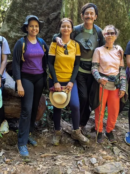 A family enjoying the Kurinjal trek together, posing in the dense forest.