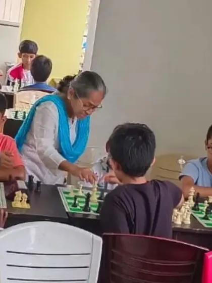An arbiter assists a young player, highlighting the supportive and well-managed nature of our chess tournaments.