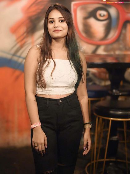 A guest posing against the venue's cool graffiti art wall.