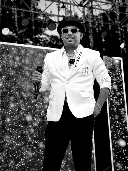 A classic black and white shot of me on stage, mic in hand. The custom jacket and confident stance reflect my professional persona as a corporate emcee, ready to take control of any event.