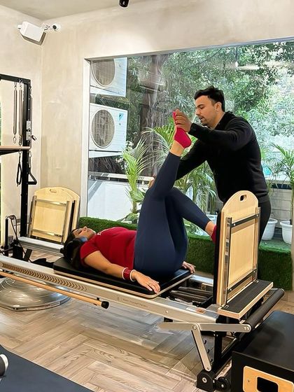 Tailored precision is the hallmark of our private training. Our instructor guides a client through a leg press on the Reformer, ensuring perfect alignment and muscle engagement.