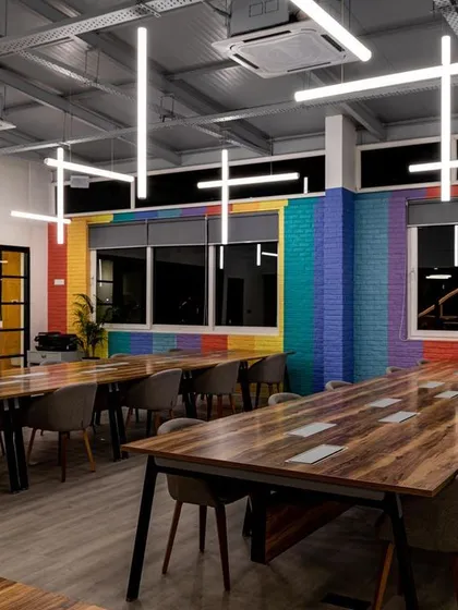 In this double-height workspace, I wanted to do more than just illuminate the room. I designed a sculptural installation with LED tube lights arranged in a dynamic pattern. This approach provides uniform, comfortable light across the desks while also acting as a unique piece of art that defines the brand's creative energy.