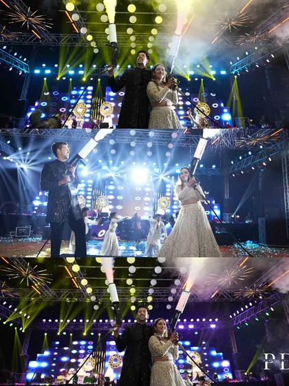 The couple's high-energy stage moment, complete with cold pyro and dramatic lighting. We work to create a stage setup that amplifies the excitement of the performances.