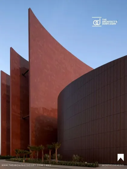 A close-up of the curved, red granite fins at the Surat Diamond Bourse. These monumental elements are not just for visual impact; they are a critical part of the passive cooling system that makes the building a benchmark in sustainable architecture.