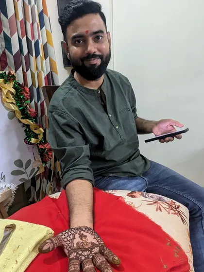 A closer look at the groom's mehendi, featuring a portrait of the bride. It’s a beautiful gesture and a unique element for wedding photos.
