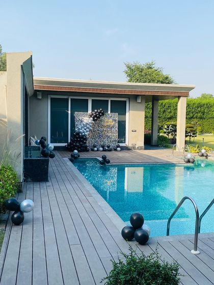 A wide shot of the modern poolside party setup.