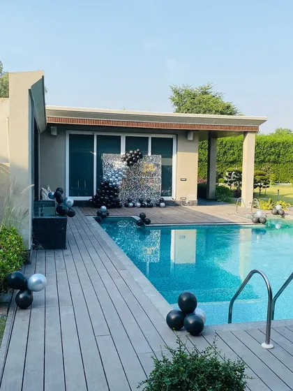 A wide shot of the modern poolside party setup.