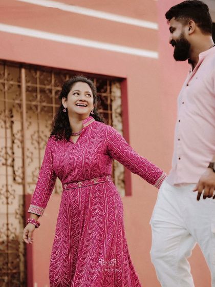 The couple walking together, the bride looking back at the groom with a radiant smile.