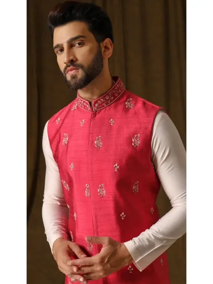 A portrait in the Gulab Dev bandi set, highlighting the intricate floral embroidery on the collar and body of the vest.